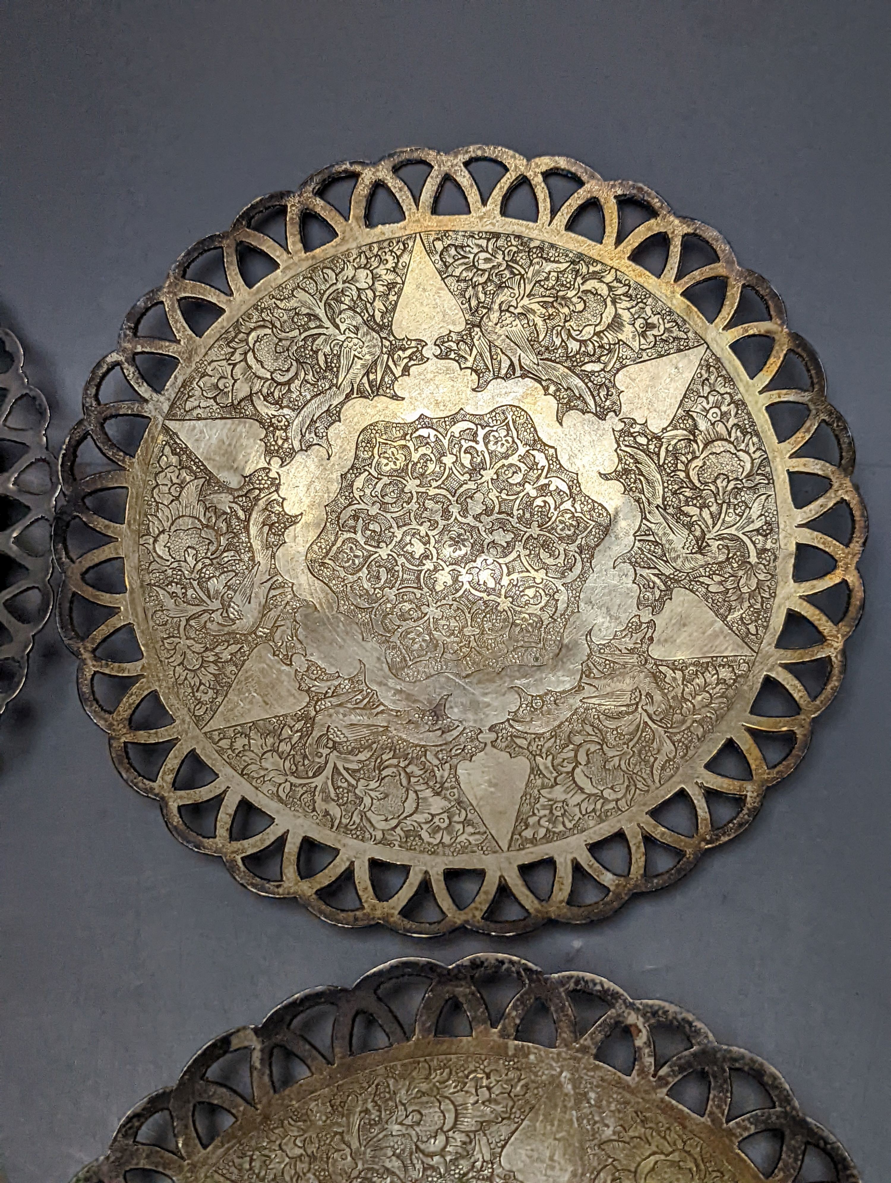 A set of six Persian white metal circular shallow dishes, with pierced borders, 16.3cm, 972 grams.